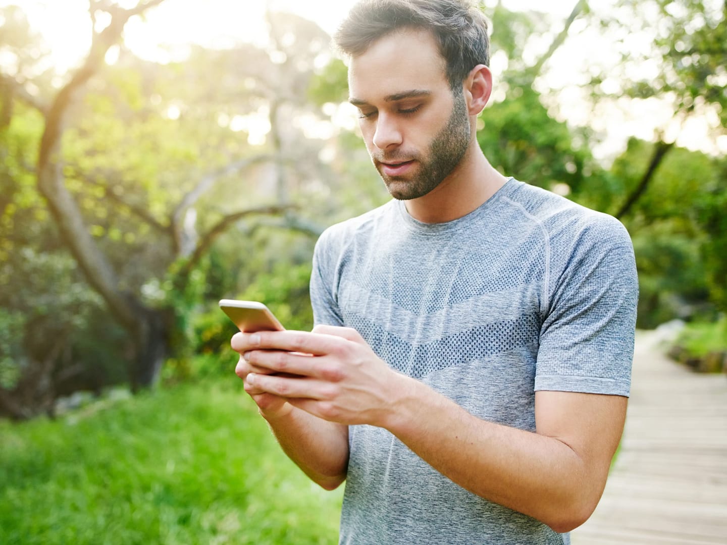 Man texting his ex at a park - why does my ex keep contacting me