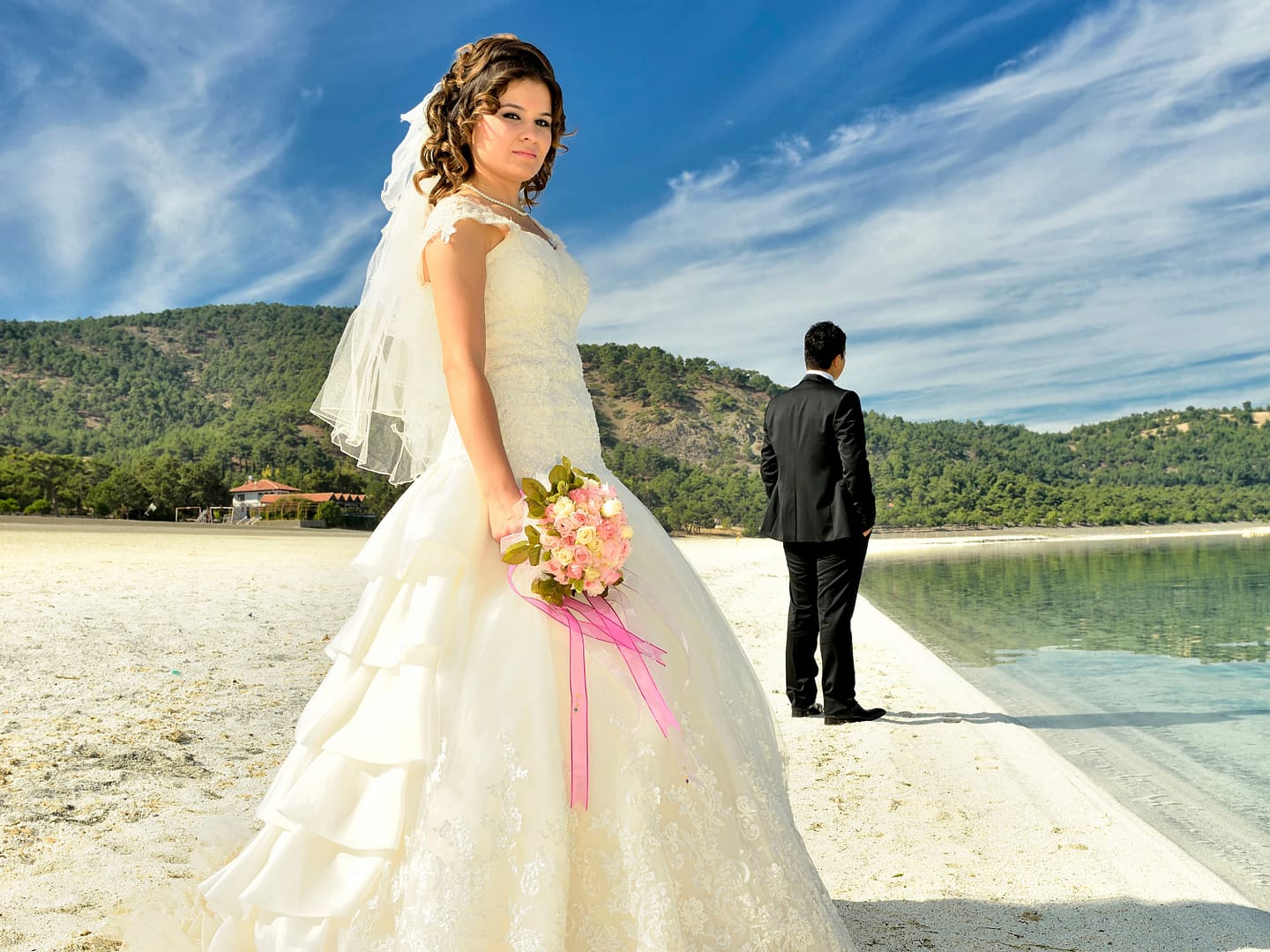 Newly-weds posing at the beach