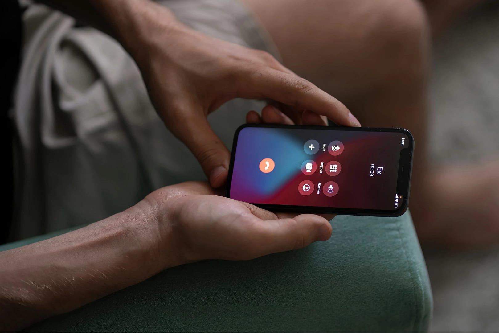 Man's hands holding an iPhone that currently is calling to his ex