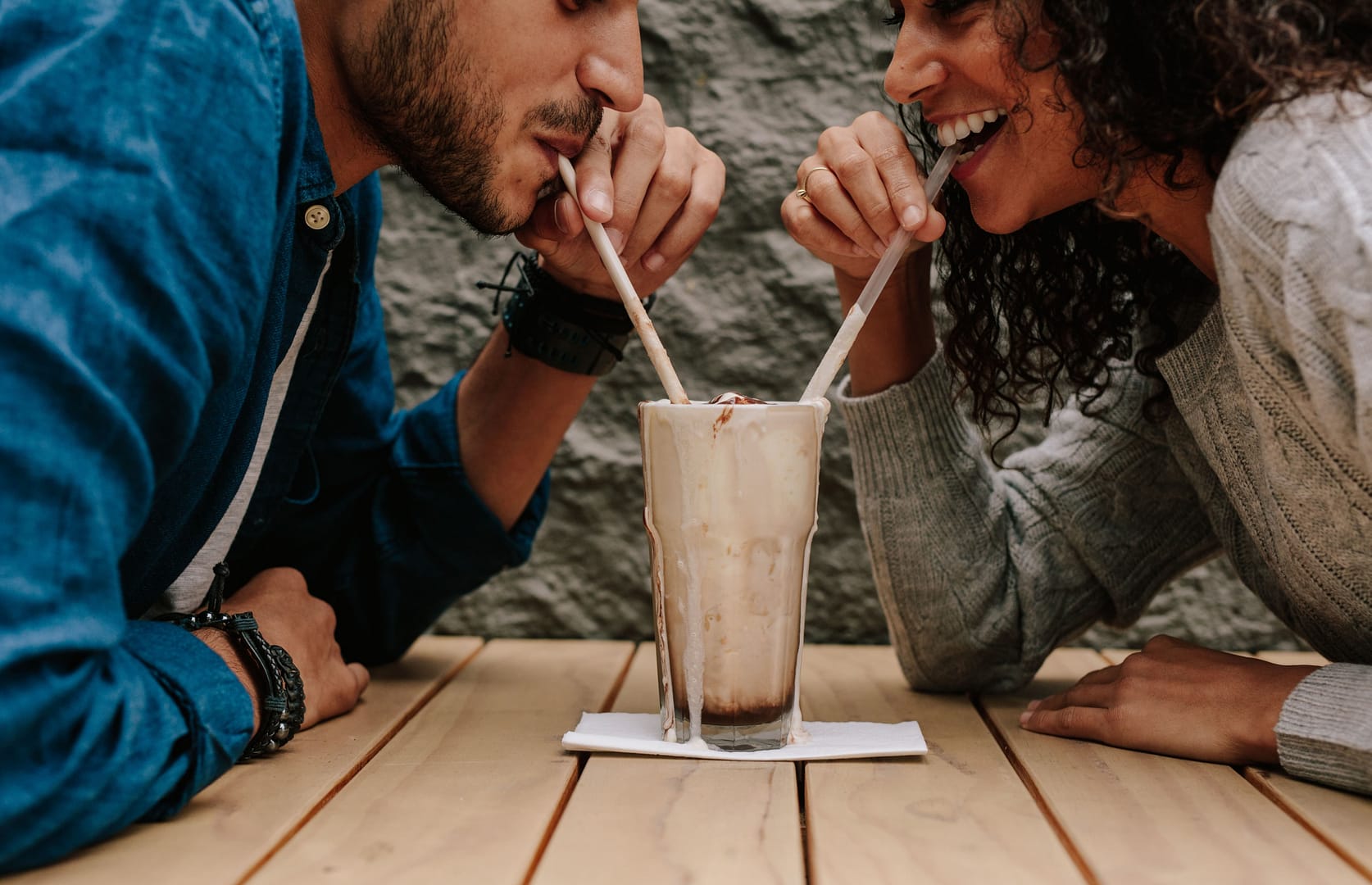 A loving couple sharing a meaningful conversation over drinks shows a strong friendship foundation for marriage.
