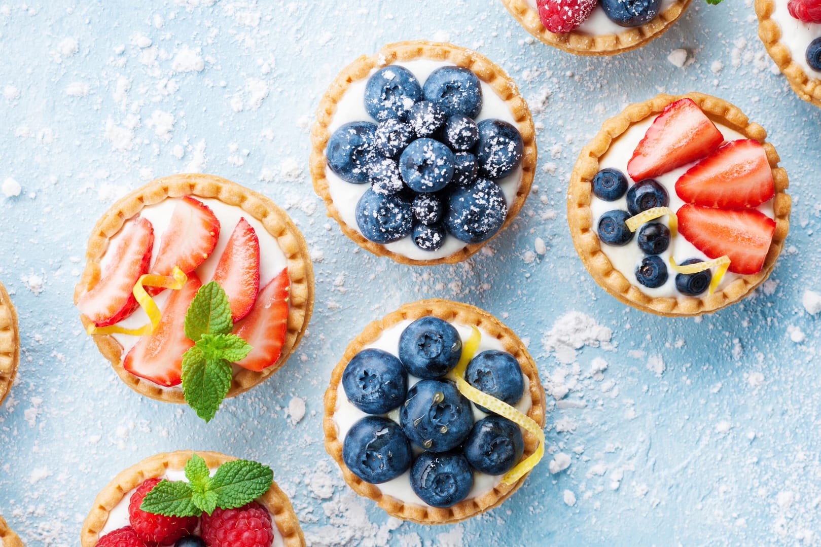 Berry tartlets or cake with cream cheese top view