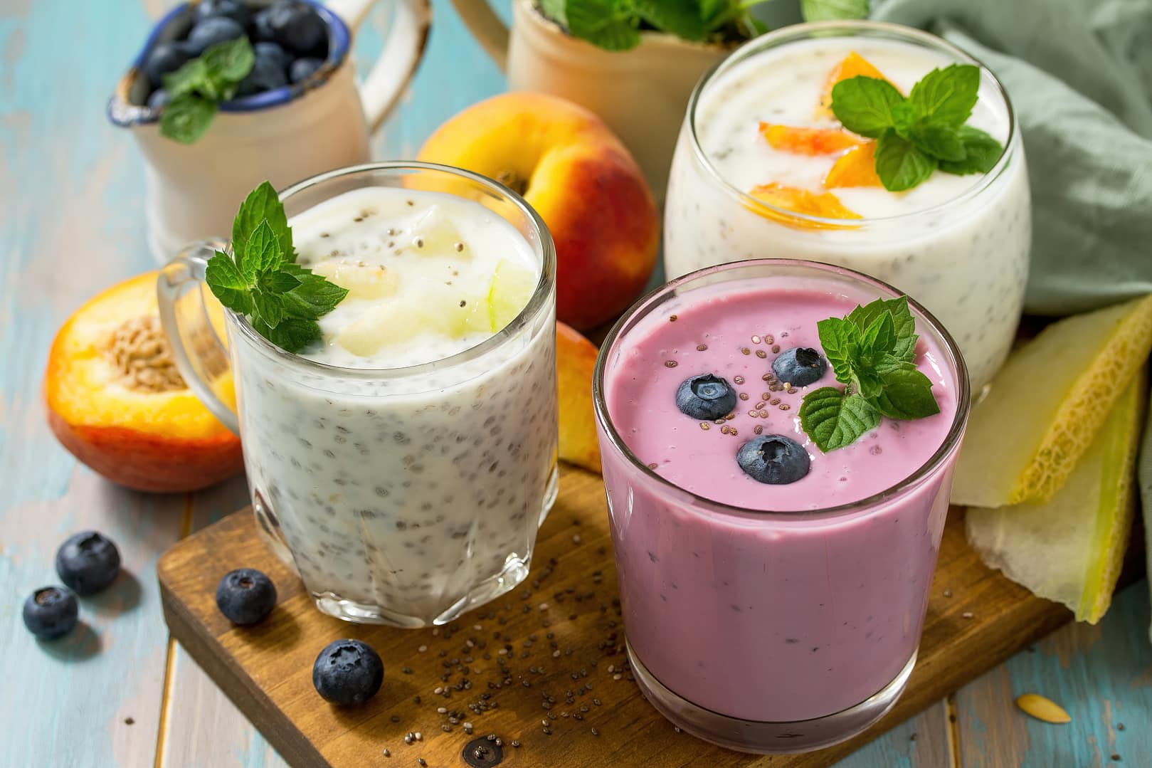 Healthy chia set. Pudding in a glass with blueberry, with melon and peach on wooden kitchen table. Healthy breakfast, vitamin snack, diet and healthy eating