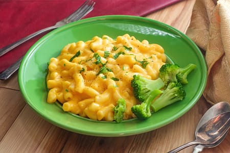 Vegan mac and cheese on a green plate