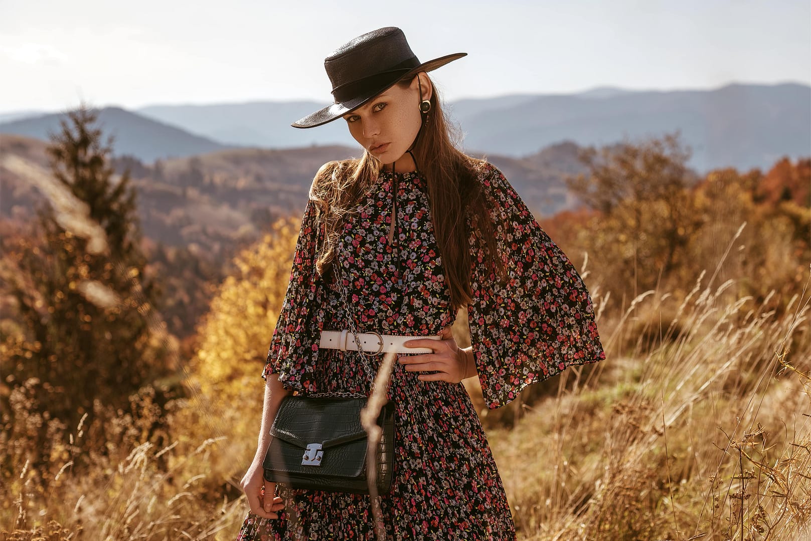 A woman is modeling six different summer dresses: blue, floral, strapless blush, green leaf print, white polka dot, and an off-the-shoulder white dress. She wears black heels with each outfit