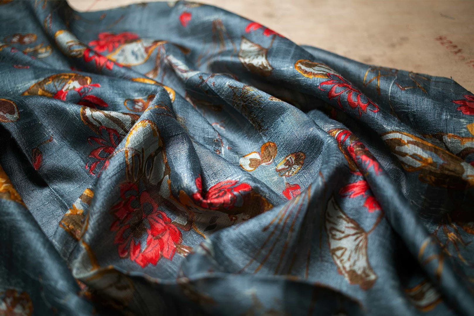 A beautiful fabric with a color of dark grey and with a image of a rose on it