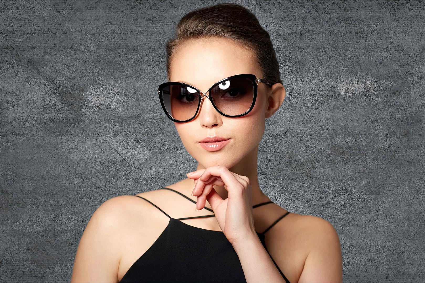 Beautiful young woman in elegant black sunglasses