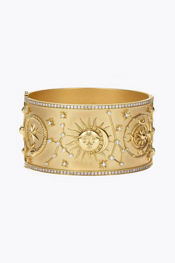 A gold bracelet featuring a celestial design of the sun, moon, and stars