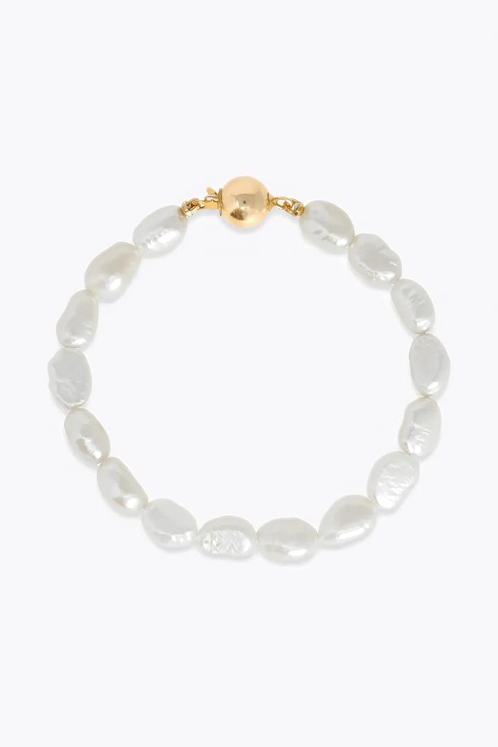 A white pearl bracelet featuring a gold plated clasp