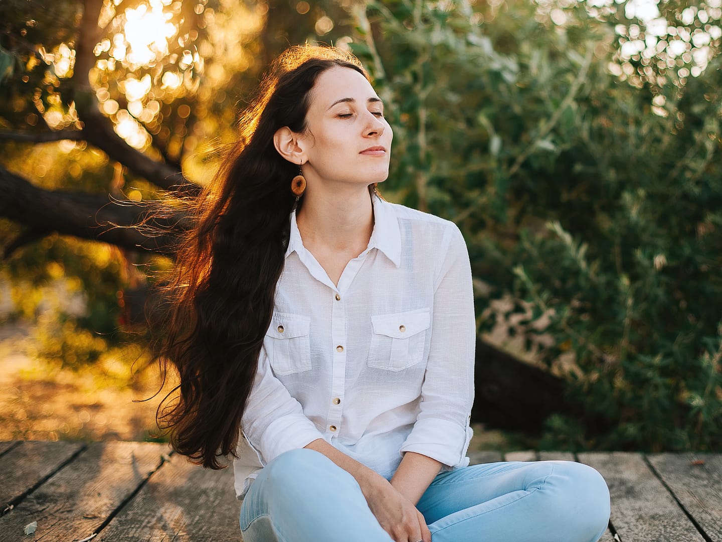 Pretty girl sitting down and feeling the wind