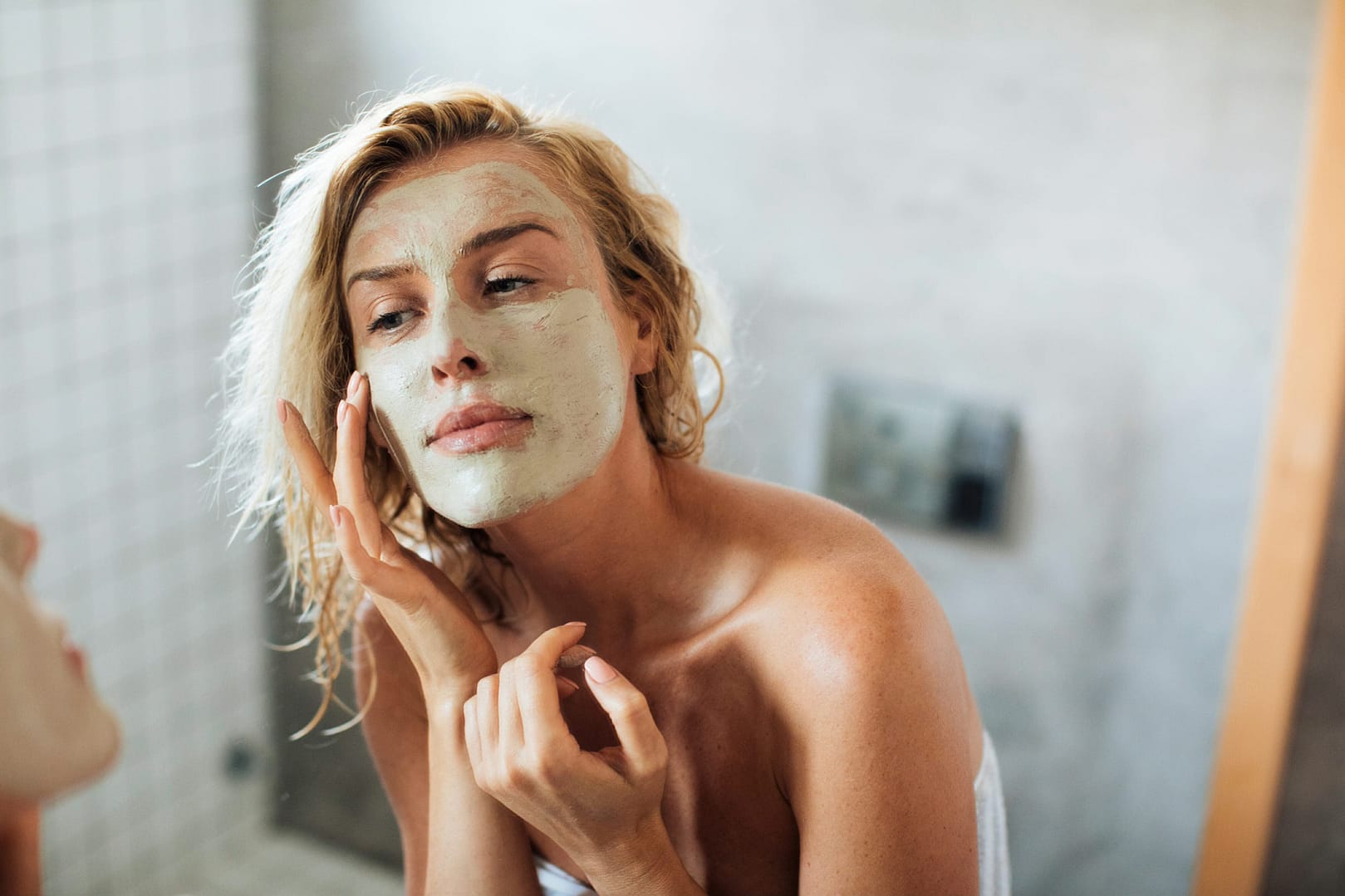 Woman applying face mask