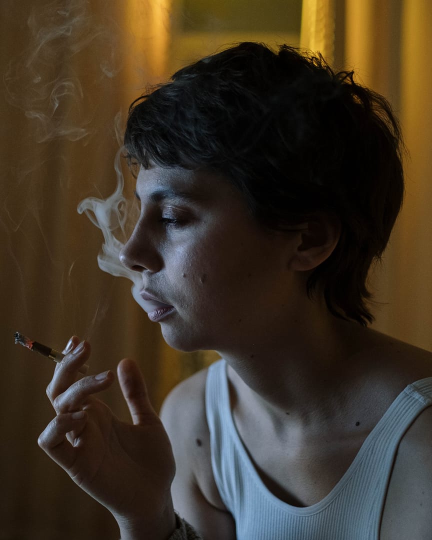 Woman with short hair smoking a cigarette