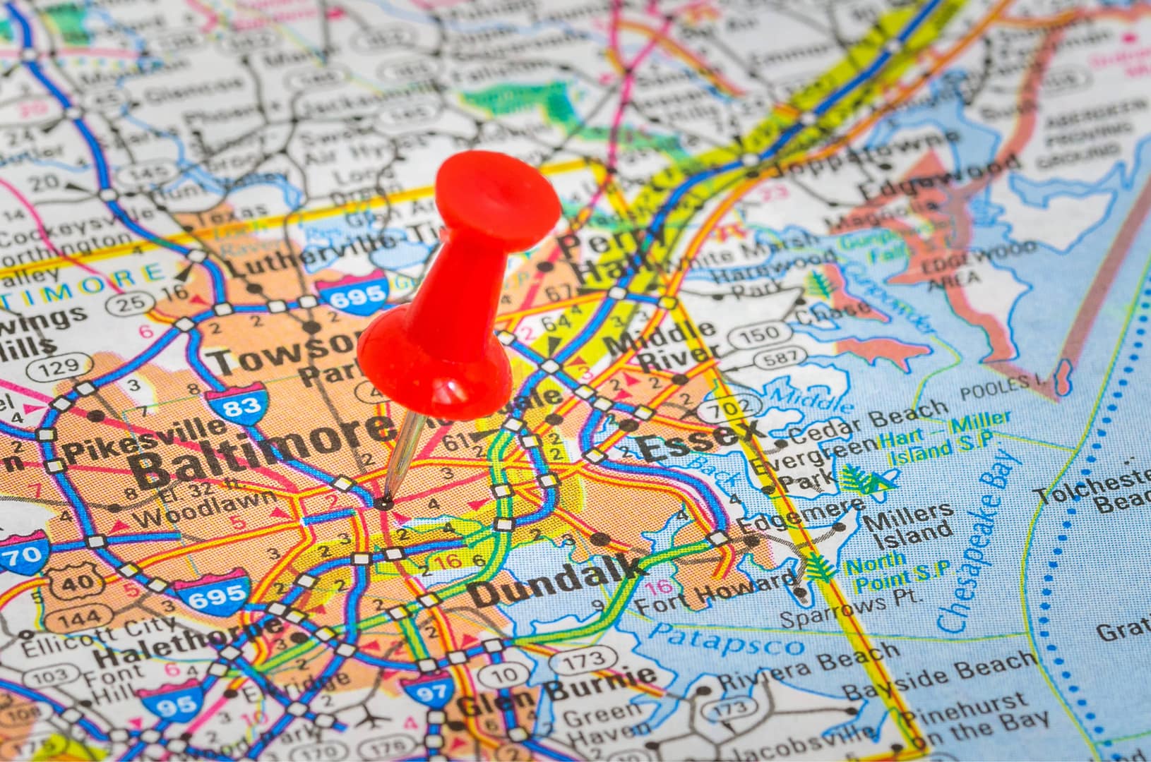 Pushpin highlighting Baltimore, MD, on a road map