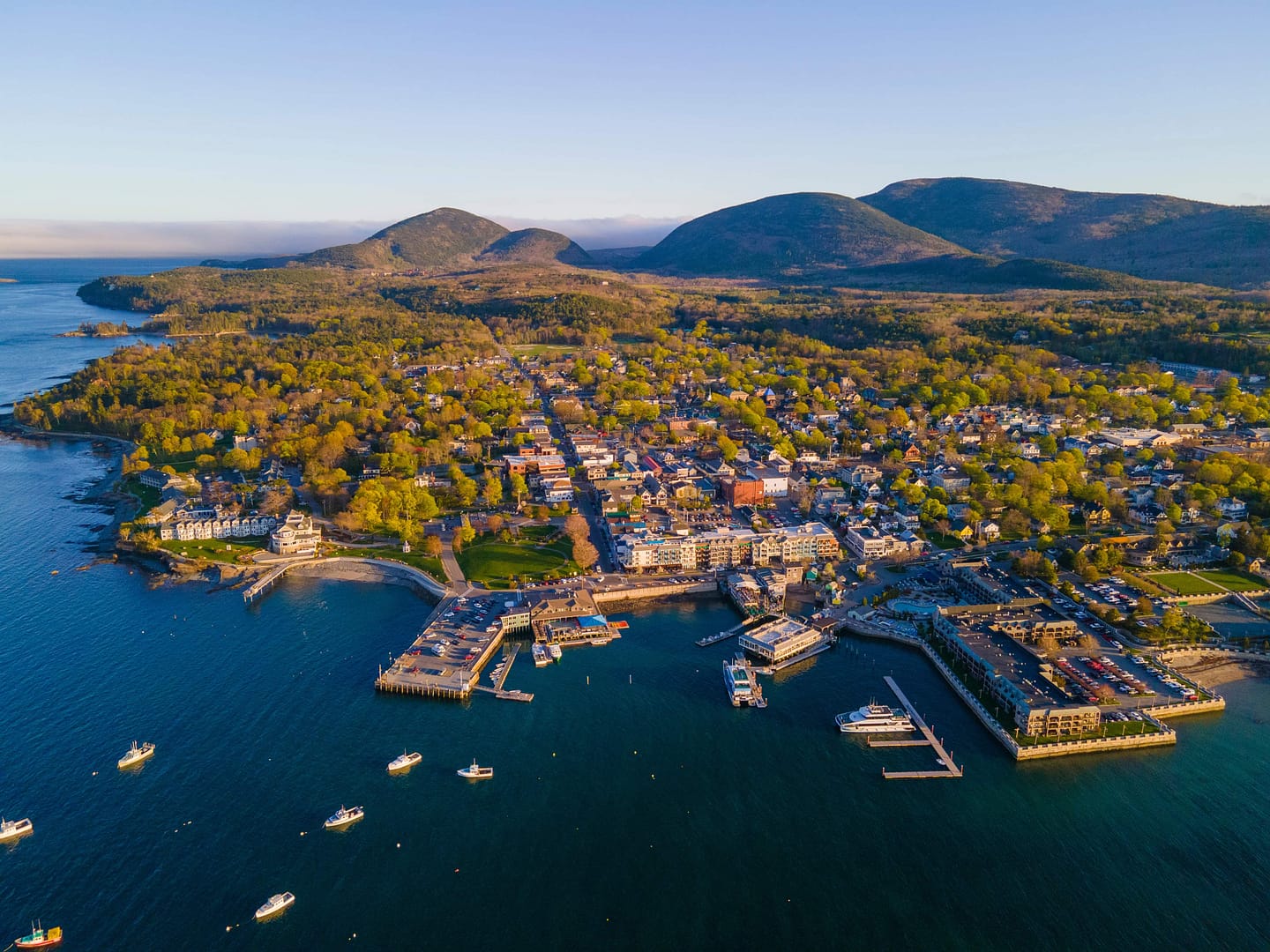 Bar Harbor historic town center aerial view at sunset, with Cadillac Mountain in Acadia National Park at the background, Bar Harbor, Maine ME, USA