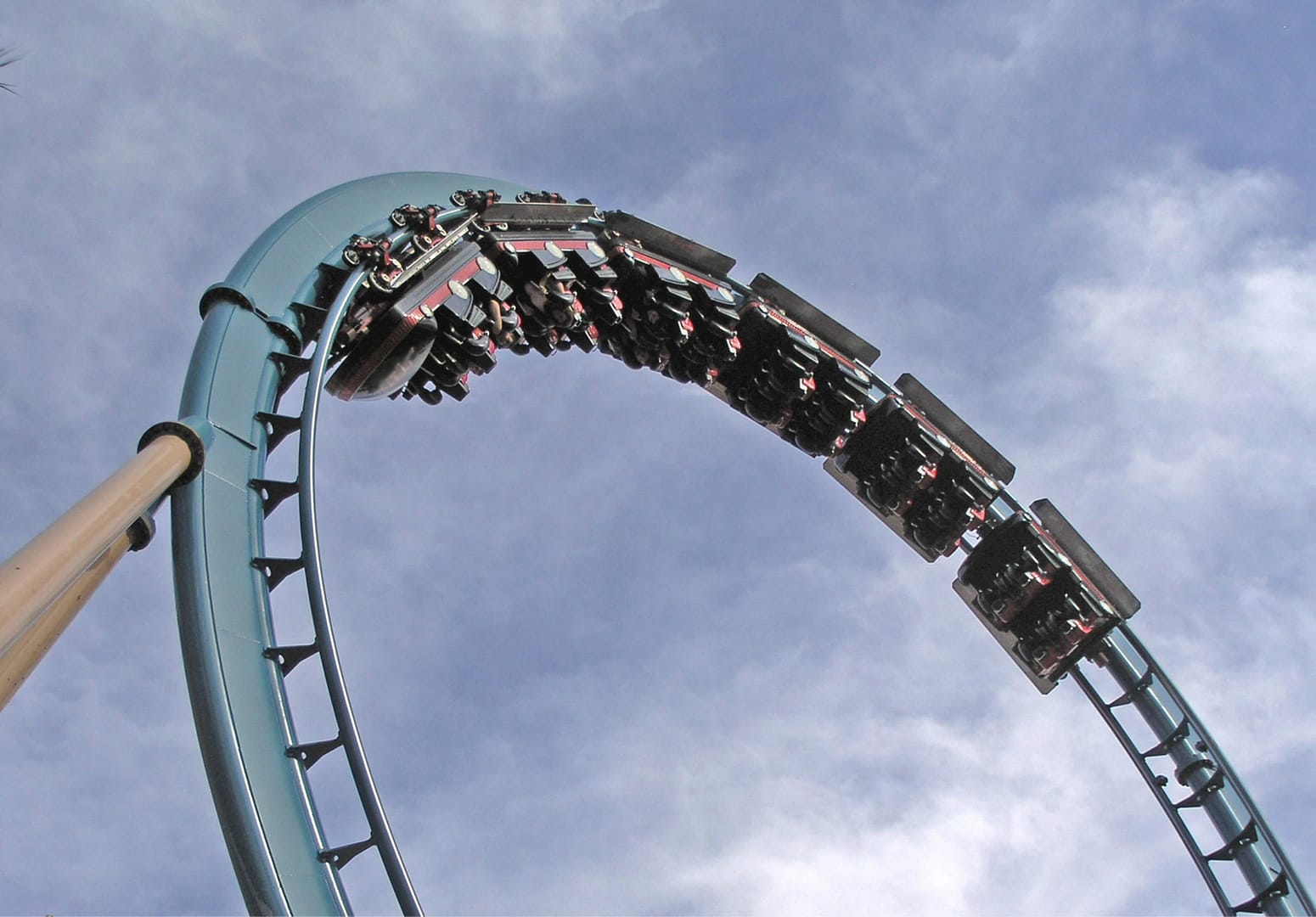 Roller coaster soaring through a clear blue sky, offering thrilling twists and turns