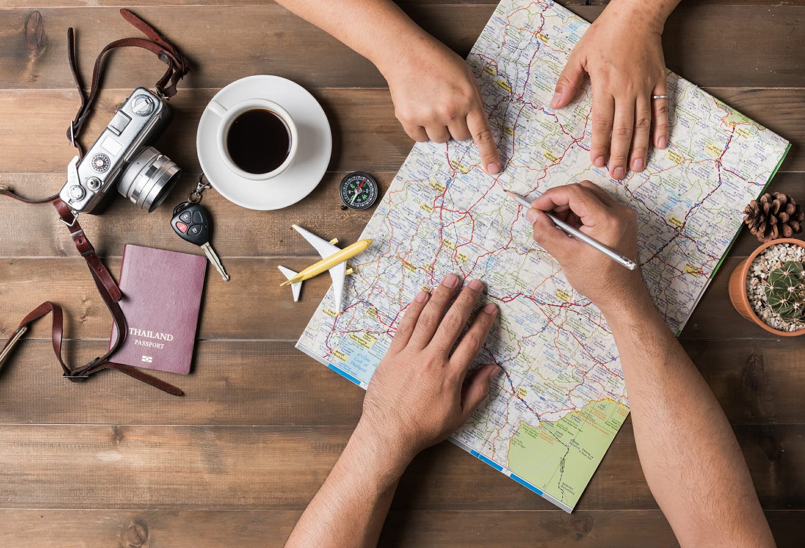Top view of young couple planning vacation trip with map