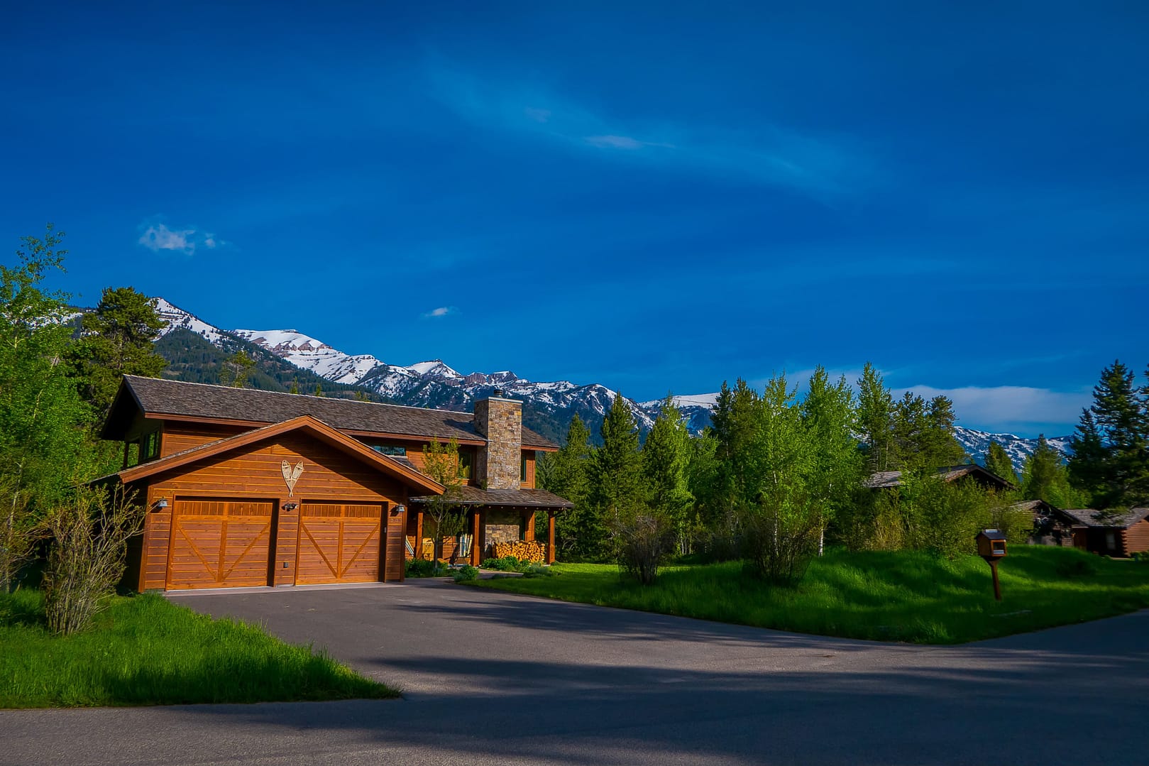 Outside view of gorgeous wooden mixed classic house buiding, located in a neighborhood in Yellowstone