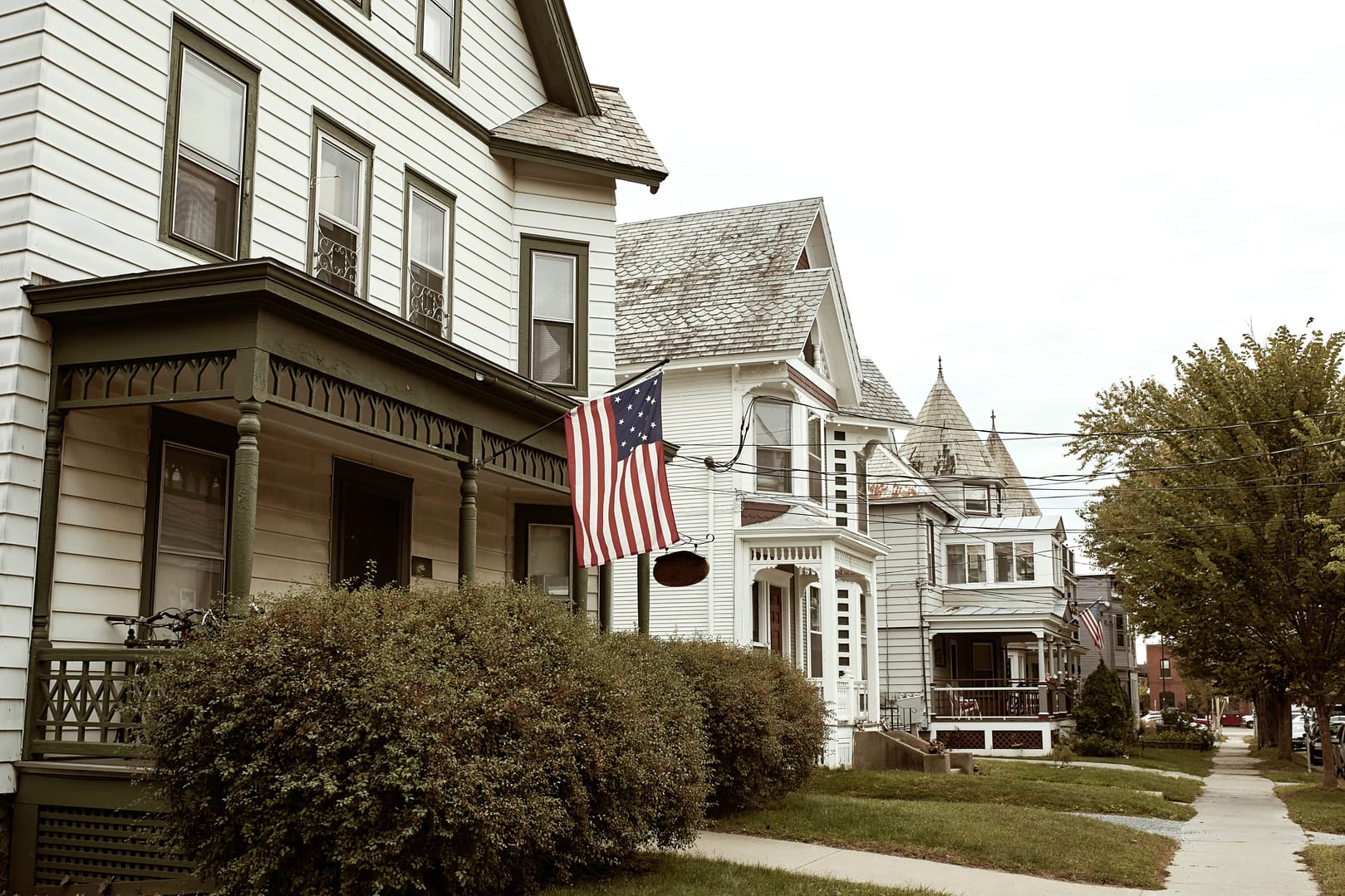 Residential street with row of white wooden houses in Burlington, Vermont