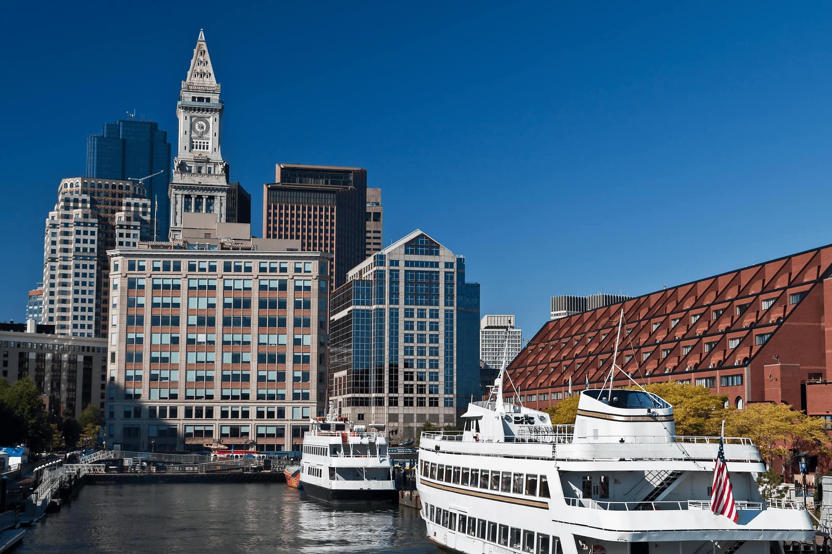 Boston Harbor cruise ships at Long Wharf with the Custom House Tower in the distance, Boston, Massachusetts, USA