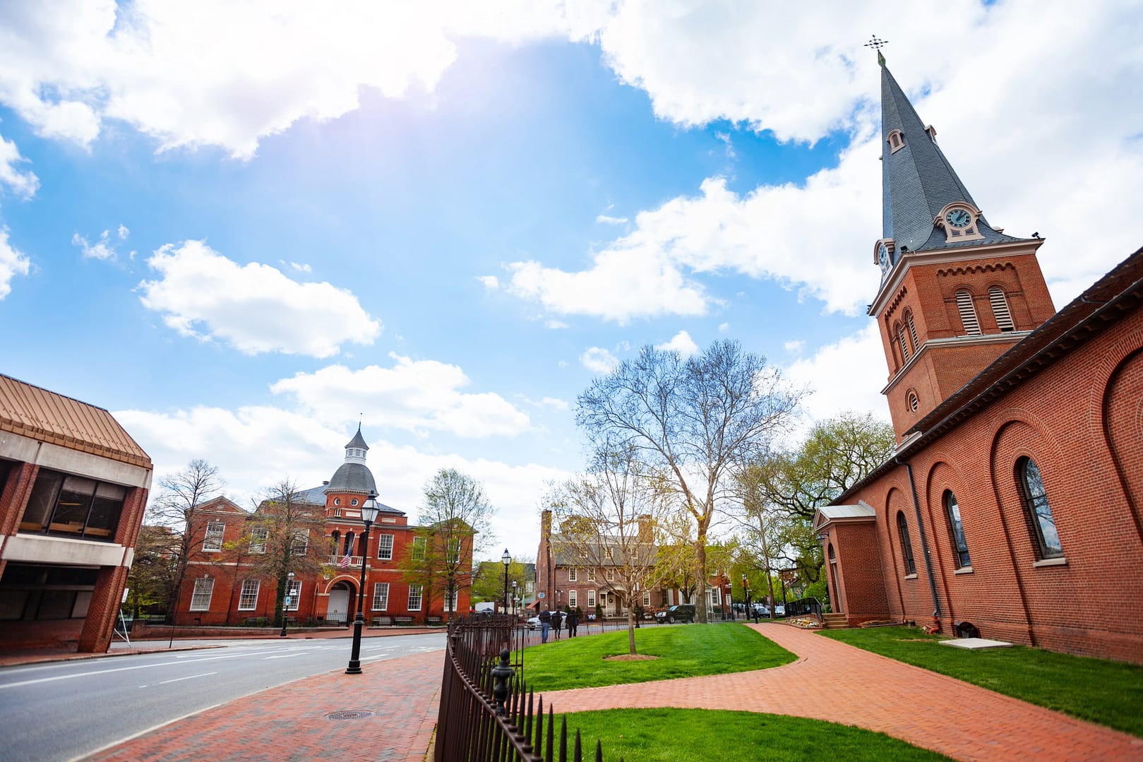 Government House and St. Anne's Parish Episcopal church in Annapolis, MA with old tree branches at spring, Maryland USA