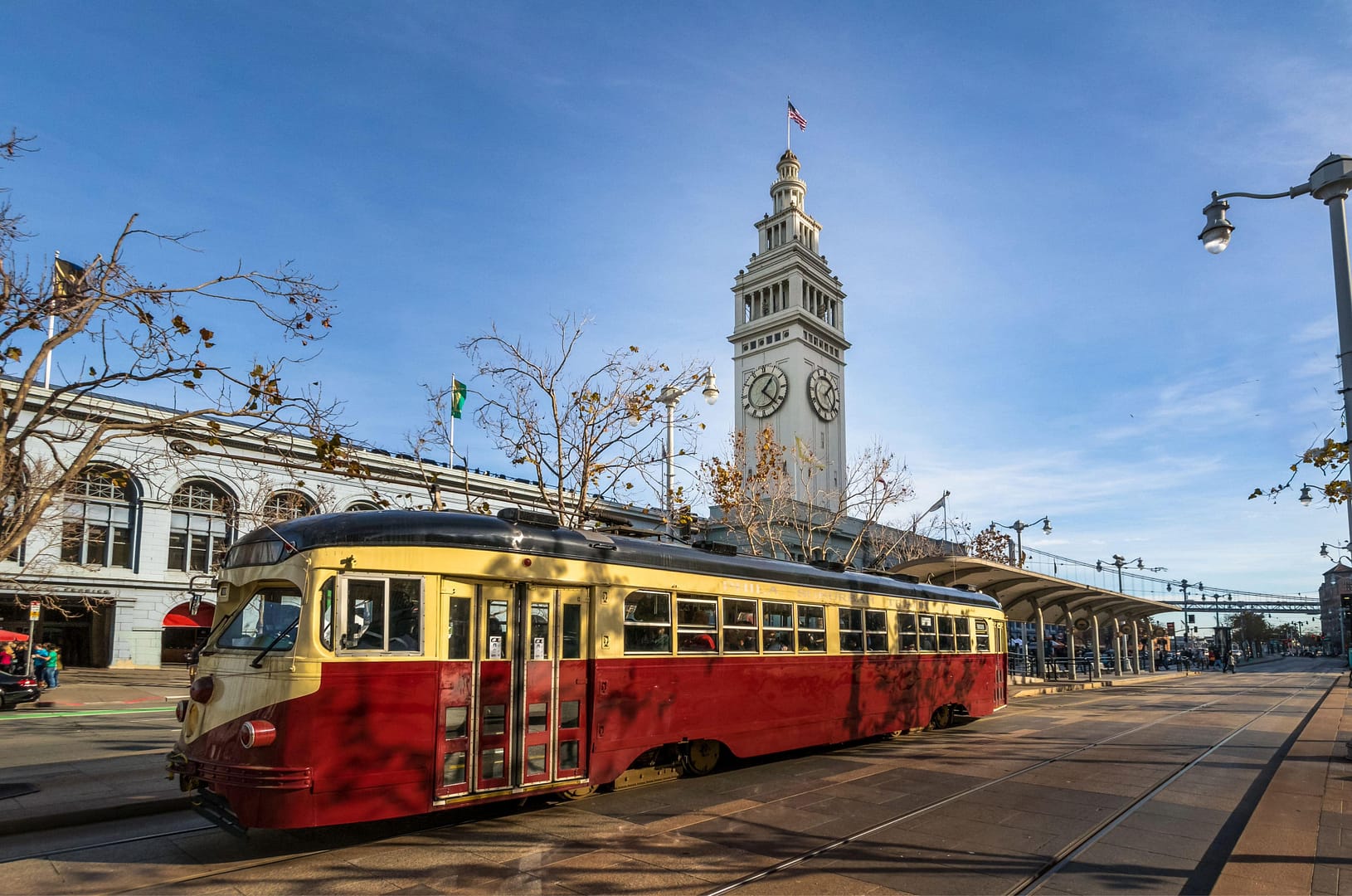 Street car or trollley or muni tram in front of San Francisco Ferry Building in Embarcadero