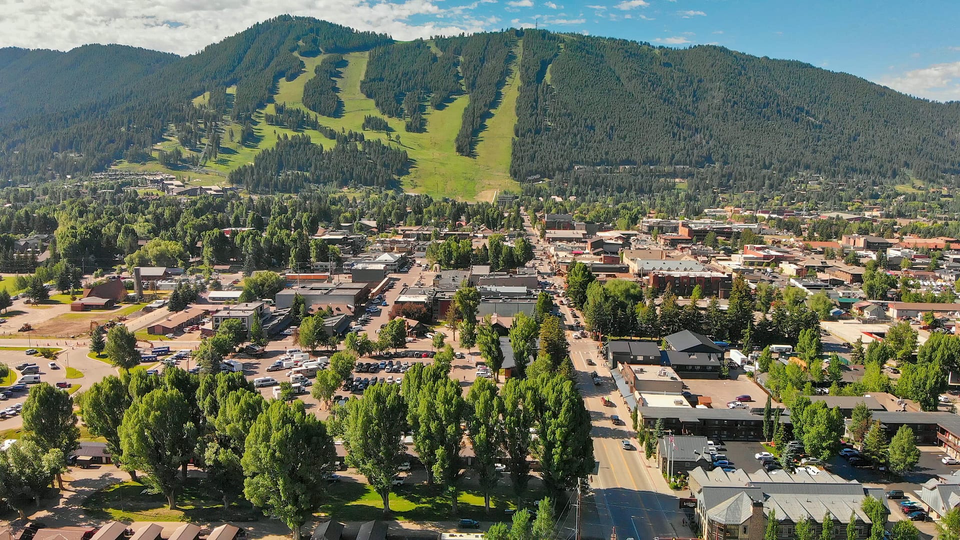 Aerial view of Jackson Hole homes and beautiful mountains on a summer morning