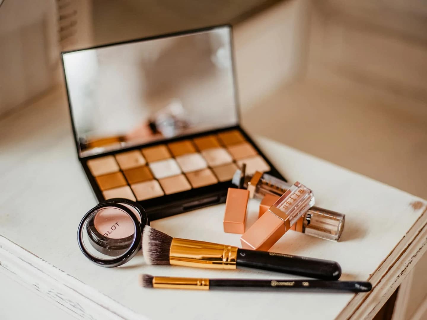 A collection of makeup brushes and cosmetics neatly arranged on a table