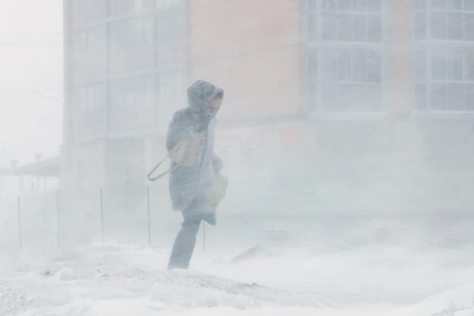 Blizzard bad weather snow and strong wind in the city selective focus