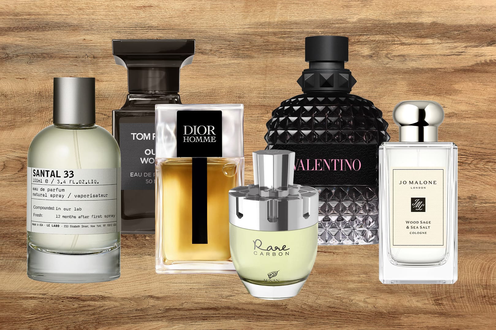 Six woody cologne bottles of various brands and designs, are arranged in a row on a wooden surface with a wood grain background