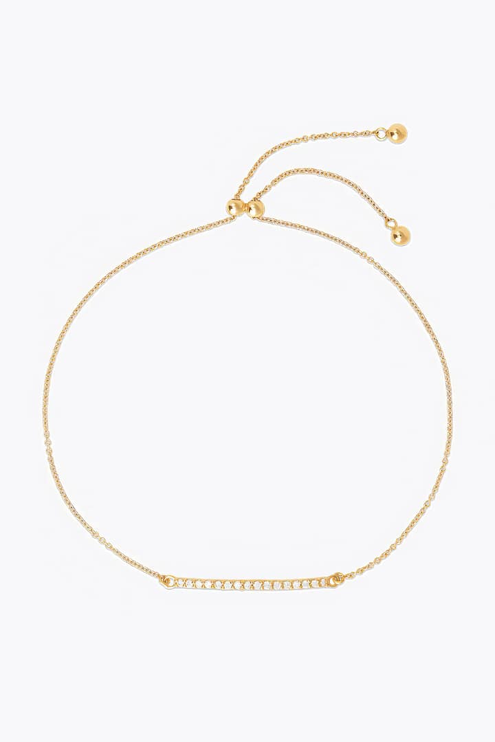 A luxurious gold bracelet featuring a delicate diamond bar