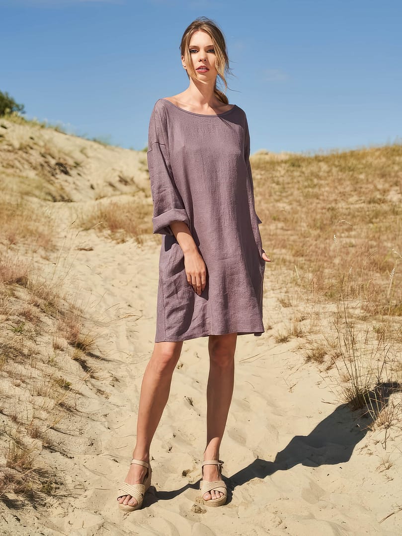 A woman wearing a linen tunic dress with long sleeves sophie