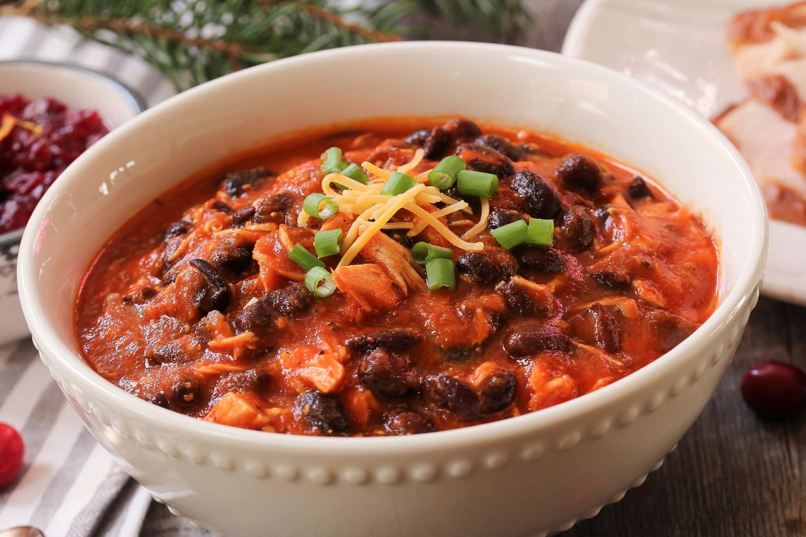 Homemade turkey chili with beans and scallions in a bowl