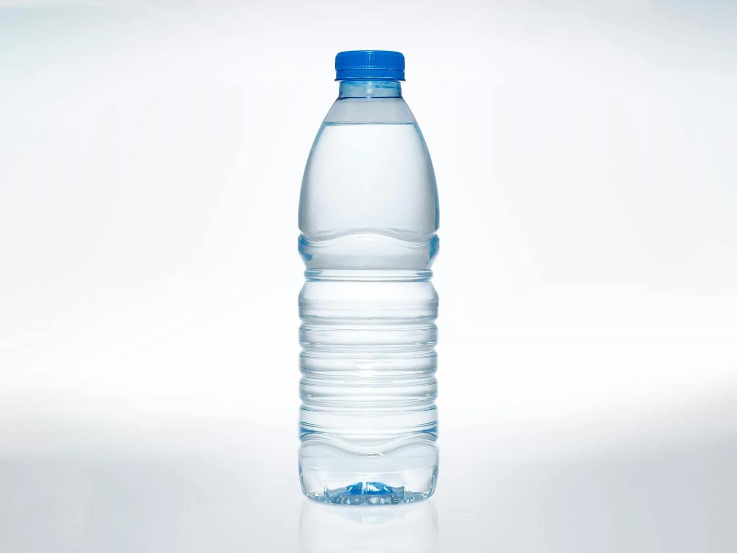 A clear plastic bottle filled with water is displayed on a plain white background