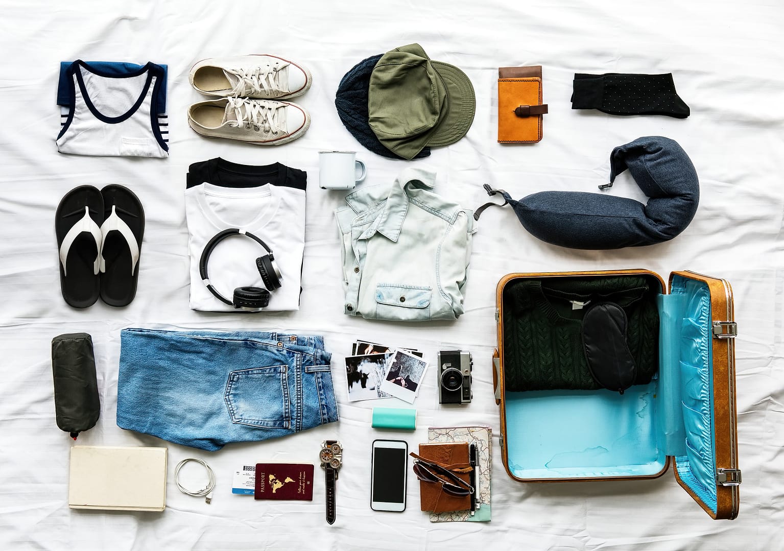 Aerial view of clothes preparing to pack on bed