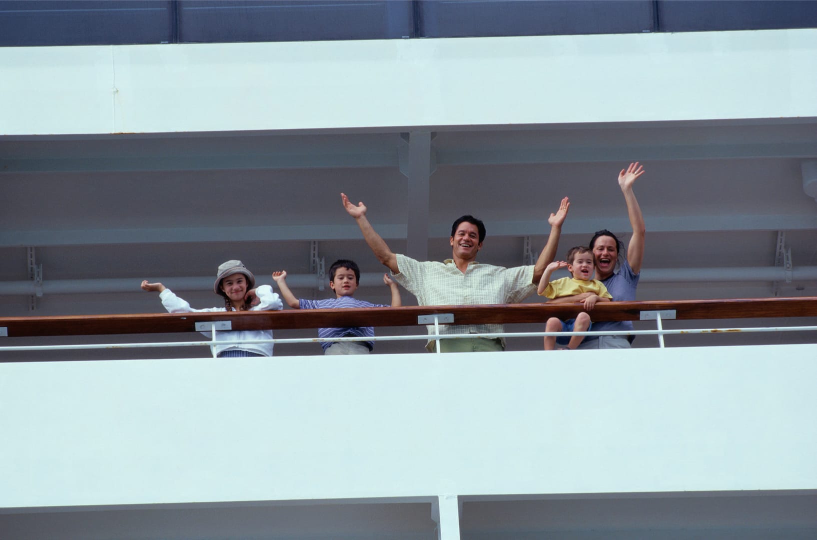 Family waving from cruise ship