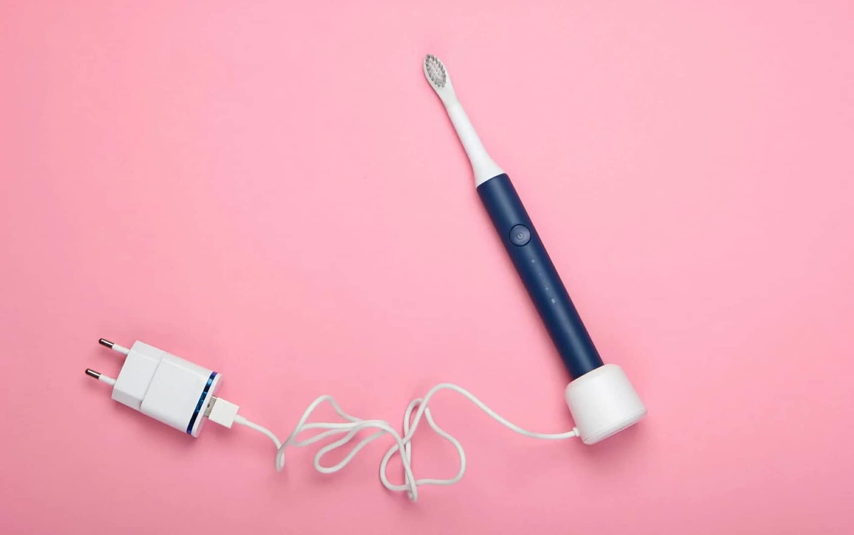 An electric toothbrush connected to a power cord